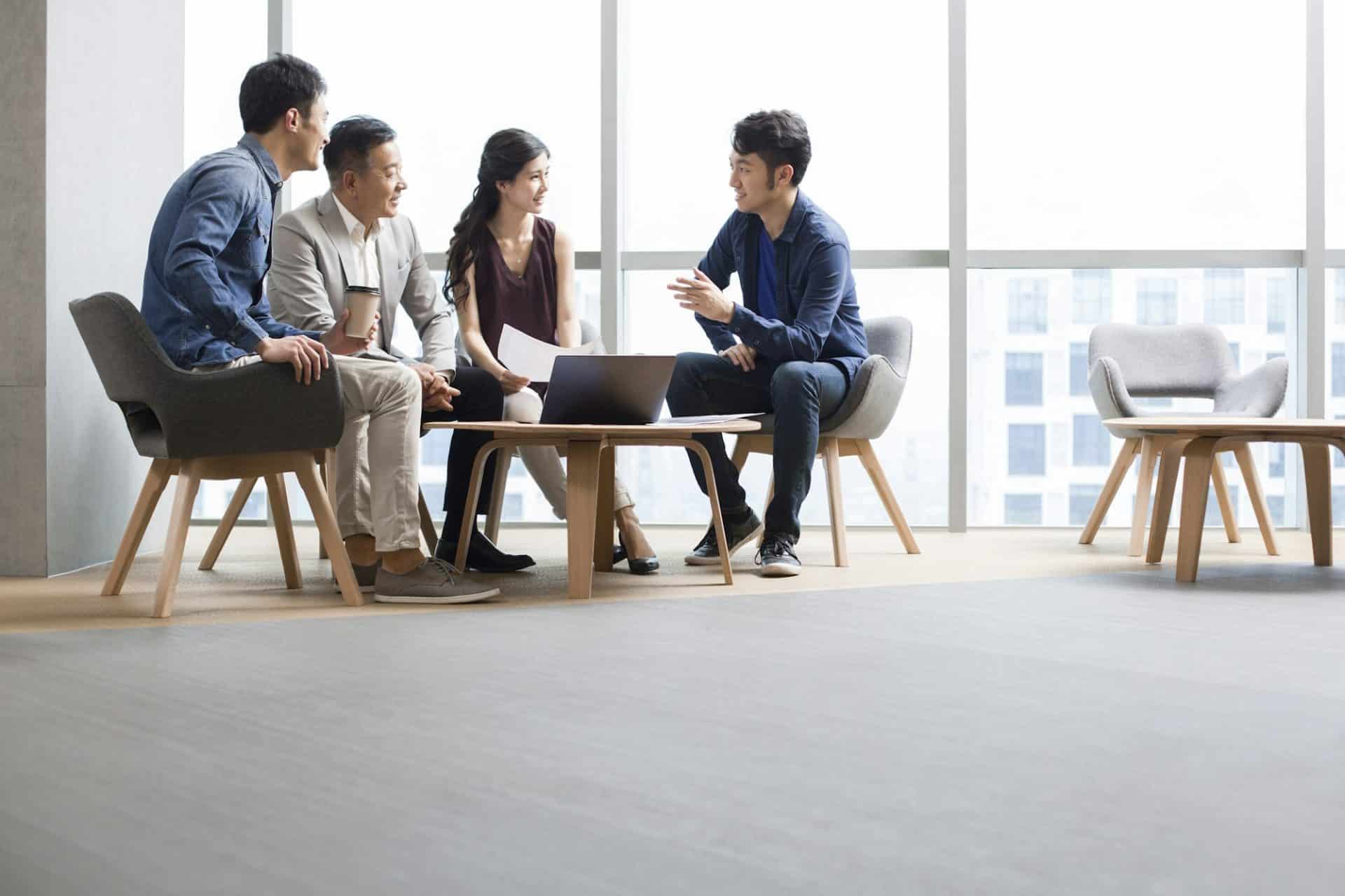 Business people talking in meeting with a laptop